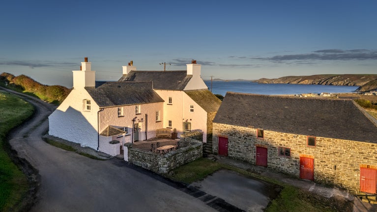 An aerial view of Newgale Wood Farm, with the sea in the distance, Pembrokeshire